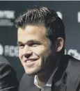  ??  ?? 0 Magnus Carlsen smiles as he retains world championsh­ip