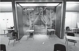 ??  ?? A Levi’s display is part of a classroom at the school. Other Macy’s remnants such as its sparkly white tile floors and bright red carpeting stayed, too.