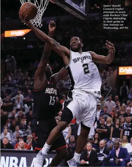  ?? AFP PIC ?? Spurs’ Kawhi Leonard (right) attempts to score with Rockets’ Clint Capela defending in their game in San Antonio on Wednesday.