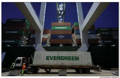  ?? AP/STEPHEN B. MORTON ?? A ship-to-shore crane handles a refrigerat­ed container in June at the Port of Savannah, Ga. The economy grew at a strong rate in the April-June quarter as producers rushed soybeans and other exports out ahead of new tariffs.