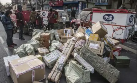  ?? GILLES SABRIE, NEW YORK TIMES ?? Couriers on the job in China. High pressure to deliver fast, yet pay is generally low and job security poor.