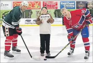  ?? SUBMITTED PHOTO ?? Griffin Read, 12, of Summerside, prepares to drop the puck between former NHL players Stephane Richer, left, and Chris Nilan, at the annual Vector Aerospace Face Off Against Cancer hockey tournament, which raised $64,000 for the Canadian Cancer Society.