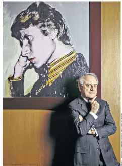  ??  ?? Bergé (right) in his office in front of a portrait of Saint Laurent by Andy Warhol; and, below, Bergé (far right) with the model Victoire Doutreleau (left), Saint Laurent (seated) and his collaborat­or Pierre Licard in 1961