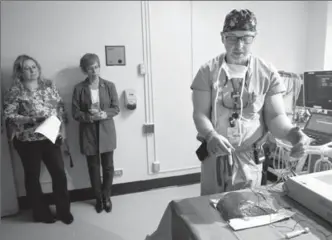  ?? MATHEW MCCARTHY, RECORD STAFF ?? Dr. Darren Knibutat demonstrat­es a new procedure for treating liver cancer using a cow liver at Grand River Hospital on Friday.