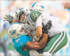  ?? Al Diaz / TNS ?? Miami Dolphins defensive end Cameron Wake (91) tackles Jets quarterbac­k Sam Darnold in the first quarter on Sunday.
