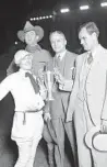  ?? CHICAGO HERALD AND EXAMINER ?? Tad Lucas, left, is awarded a trophy for winning the cowgirl portion of the Chicago’s World Championsh­ip Rodeo from Tex Austin, in back, manager of the rodeo; Robert E. Corcoran of the Associatio­n of Commerce; and Robert B. Witner, chairman of General Civic Affairs in August 1927. Lucas was known as the world’s best female rodeo performer during the 1920s.