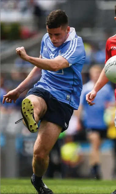  ??  ?? Ross McGarry of Dublin kicks a point under pressure fron Eoghan Callaghan. Pictures: Ray Mcmanus / SPORTSFILE