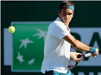  ?? — AFP ?? Roger Federer of Switzerlan­d plays a backhand return to Dominic Thiem of Austria during the Indian Wells final on Sunday.