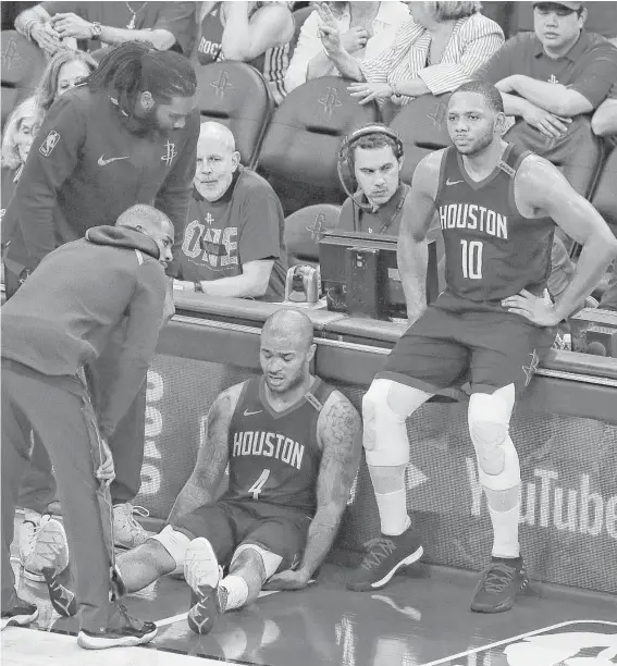  ?? Karen Warren / Houston Chronicle ?? Rockets forward P.J. Tucker (4) sits on the court next to guard Eric Gordon (10) while being consoled by an injured Chris Paul, left, at the conclusion of Game 7.