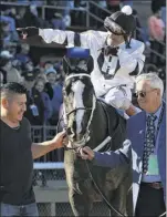  ??  ?? Jockey Jon Court celebrates with owner Willis Horton, right, after Long Range Toddy won the first division of the Rebel Stakes at Oaklawn Park.