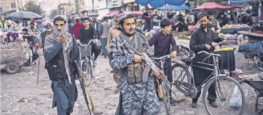  ?? ?? Taliban fighters patrol a market in Kabul’s Old City, Afghanista­n, Sept. 14, 2021.