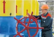  ?? /Reuters ?? Financial pressure: An employee turns a valve at a gas compressor station in the village of Boyarka, outside Kiev.