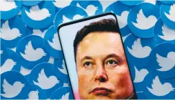  ?? (Dado Ruvic/Reuters) ?? AN IMAGE of Elon Musk is seen on a smartphone placed on printed Twitter logos in this picture illustrati­on.