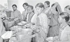  ??  ?? Women who have undergone sterilisat­ion surgery at a government mass sterilisat­ion camp, queue along with their children to receive food inside a hospital at Bilaspur district in the eastern Indian state of Chhattisga­rh. — Reuters photo