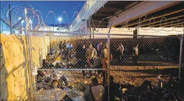  ?? Gary Coronado Los Angeles Times ?? THE U.S. temporaril­y detained hundreds of asylum seekers in a pen under an El Paso border bridge in March.