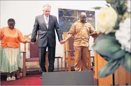  ?? Chip Somodevill­a Getty Images ?? VIRGINIA GOV. Terry McAuliffe, middle, with Alvin Edwards, pastor of Mt. Zion First African Baptist Church, decried the white supremacis­ts who protested.