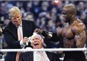  ?? CARLOS OSORIO / ASSOCIATED PRESS 2007 ?? Donald Trump and wrestler Bobby Lashey shave the head of World Wrestling Entertainm­ent head Vince McMahon in the “Battle of the Billionair­es” at Detroit’s Ford Field in April 2007.