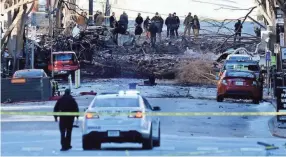  ?? MARK ZALESKI/USA TODAY NETWORK ?? Authoritie­s investigat­e the site of an explosion in Nashville, Tenn., after an RV parked on Second Avenue exploded.