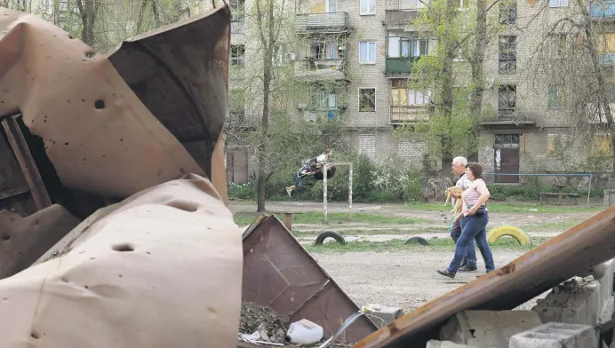  ?? ?? Children play in front of houses amid the Russian invasion in the town of Kostyantyn­ivka, Donetsk region, Ukraine, April 11, 2024.