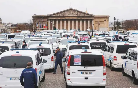  ?? AP ?? Ambulance workers block the bridge leading to the National Assembly in Paris yesterday. They took to the streets to complain about changes to working conditions as French Prime Minister Edouard Philippe held crisis talks in Paris.