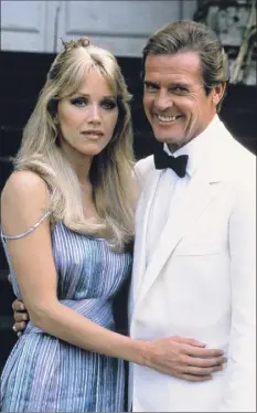  ?? Alexis Duclos / Associated Press ?? Tanya Roberts , left, poses with Roger Moore, her co-star from the James Bond film "A View to a Kill” in 1984. Roberts died Monday several hours after she was mistakenly declared dead by her publicist and her partner.