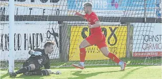  ?? ?? The ball is in the net behind Fraserburg­h goalkeeper Joe Barbour as Brora Rangers’ striker Jordan Macrae celebrates