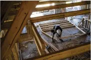  ?? TYWRIGHT / BLOOMBERG 2017 ?? Aworker saws a section of lumber inside a home under constructi­on at the Bougainvil­lea Place housing developmen­t in Ellenton, Fla.