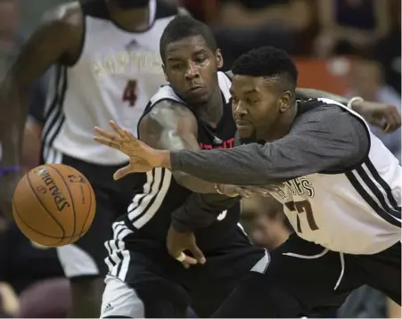  ?? ANDREW VAUGHAN/THE CANADIAN PRESS ?? Dwight Buycks, left, of the Black team battles the Grey squad’s Julyan Stone during Saturday’s Raptor intrasquad game at the Metro Centre in Halifax.