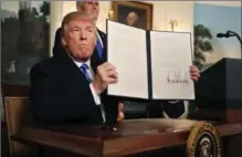  ?? CHIP SOMODEVILL­A, GETTY IMAGES ?? U.S. President Donald Trump holds up a proclamati­on that the U.S. government will formally recognize Jerusalem as the capital of Israel.