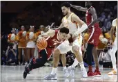  ?? WADE PAYNE — THE ASSOCIATED PRESS ?? Alabama guard Jahvon Quinerly (5) collides with Tennessee forward Olivier Nkamhoua (13) during the first half Wednesday in Knoxville, Tenn.