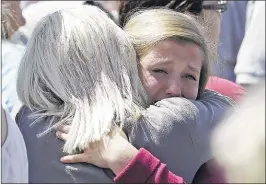  ?? Rick Bowmer/associated Press ?? Freshman Hailee siebert, 15, cries on her mothers shoulder after students arrived at a shopping center parking lot in wood Village, ore., after a shooting at reynolds High school on tuesday. A gunman killed a student at the high school east of Portland...