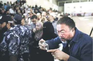  ??  ?? Ai Weiwei capturing images of refugees in Gaza with just a smartphone.