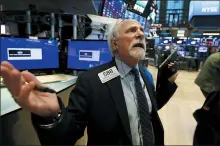  ?? RICHARD DREW — THE ASSOCIATED PRESS ?? Trader peter Tuchman works on the floor of the New York Stock Exchange, Monday, where the Dow Jones Industrial Average plummeted following similar drops in Europe after a fight among major crude-producing countries jolted investors already on edge about the widening fallout from the outbreak of the new coronaviru­s.