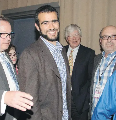  ?? TED RHODES/ CALGARY HERALD ?? A smiling Omar Khadr leaves the Globe Theatre after a question-and-answer session with the audience following the Calgary Film Festival screening of the documentar­y film Guantanamo’s Child: The Untold Story of Omar Khadr on Friday evening at SAIT.