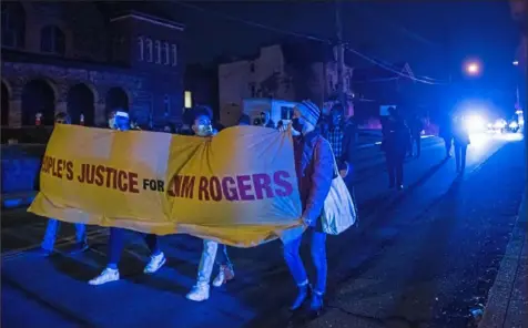  ?? Emily Matthews/Post-Gazette ?? Protesters march down Lincoln Avenue in Larimer on Tuesday to demand justice for Jim Rogers, who died after Pittsburgh police used a Taser on him.