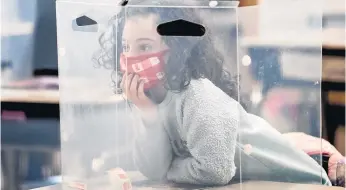  ?? KYLE TELECHAN/POST-TRIBUNE PHOTOS ?? First grader Danielle Bachar leans on her desk during class at Elliott Elementary School on March 30.