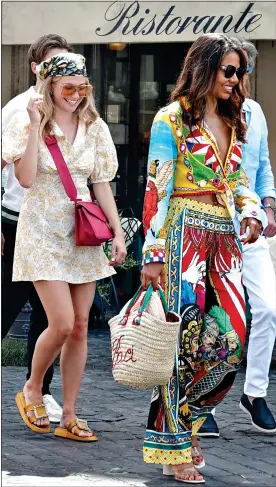  ??  ?? WHEN IN ROME: Singer Pixie Lott, left, and Viscountes­s Weymouth, carrying a D & G bag, enjoy the sights of the Italian capital before yesterday’s ceremony