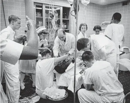  ?? Houston Chronicle file photo ?? The shock room team goes into action to save another life in January 1965 in the emergency room at Ben Taub Hospital.