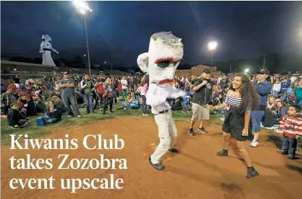  ?? LUIS SÁNCHEZ SATURNO/NEW MEXICAN FILE PHOTO ?? Zozobra attendees dance in 2015 at Fort Marcy Ballpark. The Kiwanis Club of Santa Fe is expanding its recent move toward offering premium seating and other privileges during the annual event.