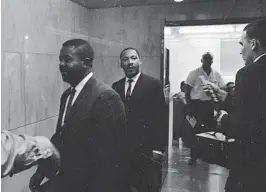  ?? AP ?? In this May 8, 1963 file photo, the Revs. Ralph Abernathy, left, and Martin Luther King, Jr. walk through a corridor of the city jail in Birmingham, Ala., where they were held for several hours following conviction on charges of parading without a permit.