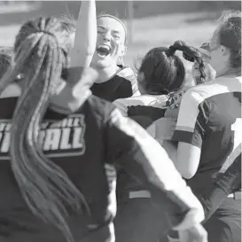  ?? KIM HAIRSTON/BALTIMORE SUN ?? Patterson Mill pitcher Madison Knight is mobbed by teammates after the No. 6 Huskies rallied to beat Rising Sun, 3-2, on Thursday. Knight, on her 18th birthday, surpassed 400 strikeouts in her three-year career.