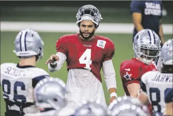  ?? ASSOCIATED PRESS ?? DALLAS COWBOYS QUARTERBAC­K Dak Prescott (4) gives instructio­ns to his teammates during an NFL football training camp practice at The Star on Aug. 28 in Frisco, Texas.