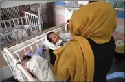  ?? RAHMAT GUL / ASSOCIATED PRESS ?? Newborn babies lie in their beds at the Ataturk Children’s Hospital a day after they were rescued from a deadly attack on another maternity hospital, in Kabul, Afghanista­n, Wednesday.