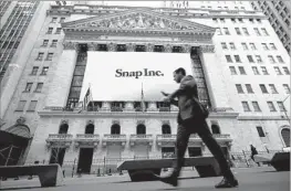  ?? Drew Angerer Getty Images ?? COMPANIES WITH less than $1 billion in revenue have been able to file financial documents confidenti­ally with the SEC since 2012, including Snap.