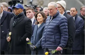  ?? JOHN MINCHILLO — THE ASSOCIATED PRESS ?? From left, New York City Mayor Eric Adams, New York Gov. Kathy Hochul, and Senate Majority Leader Chuck Schumer, D-N.Y., wait to place flowers over the names of the victims of the 1993 World Trade Center bombing during a ceremony at the 9/11 Memorial, Sunday, Feb. 26, 2023, in New York.