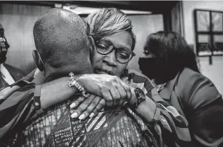  ?? Stephen B. Morton / Getty Images ?? Ahmaud Arbery’s mother, Wanda Cooper-Jones, is hugged by a supporter after the jury convicted his killers. Many Americans weren’t confident that would be the outcome.