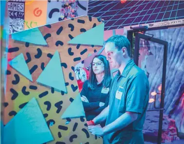  ?? ROBERTO E. ROSALES/JOURNAL ?? Carrie Velasquez and Nick Velasquez, alumni of Leadership New Mexico, play in the arcade area of Meow Wolf in Santa Fe during a recent visit.