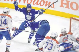  ?? USA TODAY SPORTS ?? Toronto Maple Leafs forward Auston Matthew (34) celebrates with forward Zach Hyman after Hyman scored against Montreal Canadiens in game five of the first round of the 2021 Stanley Cup Playoffs at Scotiabank Arena.