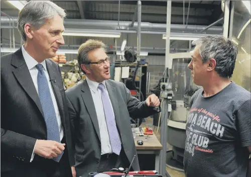  ?? PICTURE BRUCE ROLLINSON. ?? SHOP FLOOR: Then defence secretary Philip Hammond and Calder Valley MP Craig Whittaker talk to John Clegg at Brunswick Tooling, Brighouse in 2014.