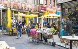  ?? PHILLIP REED WASHINGTON POST PHOTOS ?? Patrons sit at temporary outdoor seating in China Town, Manhattan.